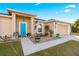 Charming one-story home with teal door and landscaped yard at 6560 Sw 129Th St, Ocala, FL 34473