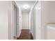 Long hallway with dark wood flooring and linen closet at 6560 Sw 129Th St, Ocala, FL 34473