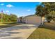 Single story house with American flag, landscaping and a long driveway at 6560 Sw 129Th St, Ocala, FL 34473