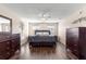 Main bedroom with dark wood furniture and large windows at 6560 Sw 129Th St, Ocala, FL 34473