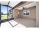 Covered screened porch with ceiling fan and backyard view at 9744 Sw 63Rd Loop, Ocala, FL 34481