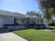 One-story home with gray exterior, landscaped lawn, and attached garage at 11354 Sw 138Th Pl, Dunnellon, FL 34432