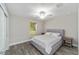 Spacious bedroom with grey bed, wood-look floors, and large window at 176 Pine Crse, Ocala, FL 34472