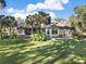 House with a large backyard, lush landscaping, and a pool at 3225 Nw 79Th Avenue Rd, Ocala, FL 34482