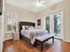 Guest bedroom with wood floors, plantation shutters, and private access to patio at 3225 Nw 79Th Avenue Rd, Ocala, FL 34482