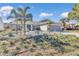 Landscaped front yard with palm trees and a walkway to the home entrance at 3923 Manor Oaks Ct, Leesburg, FL 34748