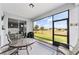 Screened porch with glass doors, overlooks a large backyard at 6035 Sw 93Rd Cir, Ocala, FL 34481