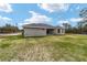 House exterior showcasing a large backyard at 8540 Sw 136Th Ter, Dunnellon, FL 34432