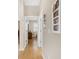 Bright hallway with light wood floors and framed photos at 9083 Sw 99Th Court Rd, Ocala, FL 34481