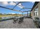 Covered patio with table and chairs, overlooking a lake at 9146 Sw 65Th Loop, Ocala, FL 34481