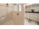 Walk-in shower with neutral tile and a built-in bench at 9146 Sw 65Th Loop, Ocala, FL 34481
