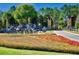 Close-up view of the Stone Creek entrance sign, vibrant flowers, and cascading water features at 9146 Sw 65Th Loop, Ocala, FL 34481