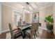 Spacious dining room with hardwood floors, a glass dining table, and modern decor at 9146 Sw 65Th Loop, Ocala, FL 34481