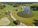 Scenic aerial view of the golf course featuring a pond with a fountain and surrounding greenery at 9146 Sw 65Th Loop, Ocala, FL 34481