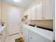 Laundry room with built-in cabinets, sink, and washer/dryer at 9146 Sw 65Th Loop, Ocala, FL 34481