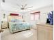 Bright bedroom with a king-size bed and ceiling fan at 9220 Sw 104Th Pl, Ocala, FL 34481