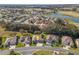Bird's-eye view of a house in a residential neighborhood near a lake and golf course at 12157 Se 175Th Loop, Summerfield, FL 34491