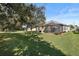Large backyard with screened patio and lush lawn at 12157 Se 175Th Loop, Summerfield, FL 34491