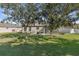Spacious backyard with large trees and grassy area at 12157 Se 175Th Loop, Summerfield, FL 34491