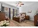 Main bedroom with wood furniture and ceiling fan at 12157 Se 175Th Loop, Summerfield, FL 34491