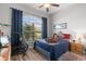 Bright bedroom with a double bed, large window, and wood-look floors at 12157 Se 175Th Loop, Summerfield, FL 34491