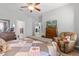 Main bedroom with comfy recliner and ceiling fan at 12157 Se 175Th Loop, Summerfield, FL 34491