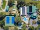 Aerial view of community amenities including tennis courts, pool, and clubhouse at 12157 Se 175Th Loop, Summerfield, FL 34491