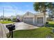 House exterior showcasing a three-car garage and manicured lawn at 12157 Se 175Th Loop, Summerfield, FL 34491