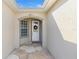 Front entry with a charming white door and stone flooring at 12157 Se 175Th Loop, Summerfield, FL 34491