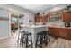 Spacious kitchen with island, wood cabinets, and stainless steel appliances at 12157 Se 175Th Loop, Summerfield, FL 34491