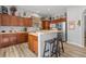 Modern kitchen featuring wood cabinets, stainless steel appliances, and an island at 12157 Se 175Th Loop, Summerfield, FL 34491