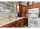 Modern kitchen with white appliances and wood cabinets at 12157 Se 175Th Loop, Summerfield, FL 34491