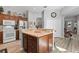 Bright kitchen with an island, wood cabinets, and updated flooring at 12157 Se 175Th Loop, Summerfield, FL 34491