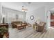 Living room with comfortable seating and a view of the kitchen at 12157 Se 175Th Loop, Summerfield, FL 34491