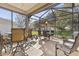 Spacious screened patio with table, chairs, and an umbrella at 12157 Se 175Th Loop, Summerfield, FL 34491