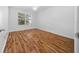 Bright bedroom featuring wood-look floors and a large window at 1579 Latta Ct, The Villages, FL 32162