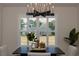 Dining area with modern chandelier and windows overlooking a grassy yard at 1725 W Hwy 329, Citra, FL 32113