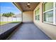 Covered screened porch with a ceiling fan and view of the backyard at 187 Hickory Course Trce, Ocala, FL 34472