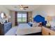 Spacious main bedroom with a large window and a navy blue headboard at 296 Hickory Course Trl, Ocala, FL 34472