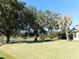 Landscaped backyard with pond and mature trees at 3282 Sw 9Th Ave, Ocala, FL 34471