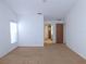 Large bedroom with plush carpeting and access to the bathroom and hallway at 3282 Sw 9Th Ave, Ocala, FL 34471