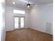 Bright bedroom with carpeting, french doors, and ceiling fan at 3282 Sw 9Th Ave, Ocala, FL 34471