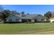 One-story home with green lawn and mature trees at 3282 Sw 9Th Ave, Ocala, FL 34471