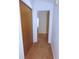 Hallway with wood-paneled doors and carpet at 3282 Sw 9Th Ave, Ocala, FL 34471