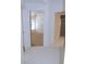 White tiled hallway with doors to bedrooms and bathroom at 3282 Sw 9Th Ave, Ocala, FL 34471