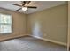 Bright bedroom featuring carpet flooring and a ceiling fan at 5888 Sw 123Rd Avenue Rd, Ocala, FL 34481