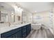 Elegant bathroom with double vanity, soaking tub, and marble tile at 6610 Sw 109Th Ln, Ocala, FL 34476