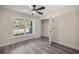 Well-lit bedroom with hardwood floors, a large window, and closet at 6610 Sw 109Th Ln, Ocala, FL 34476