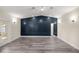 Large living room with gray vinyl plank flooring and a statement wall at 6610 Sw 109Th Ln, Ocala, FL 34476