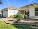 House exterior showcasing walkway, landscaping, and garage at 725 Beldon Ct, The Villages, FL 32162